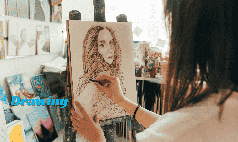 A woman drawing on paper with pencils and sketching tools.