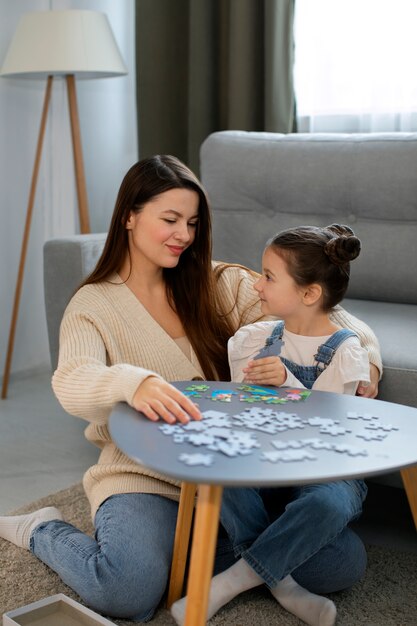 A person quietly solving a jigsaw puzzle on a table with natural light, surrounded by scattered puzzle pieces — a relaxing and mentally stimulating hobby for introverts.