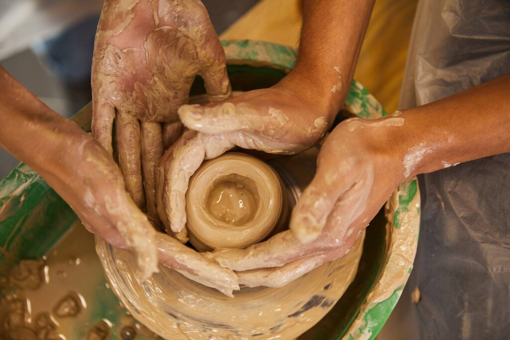 Hands shaping clay on a pottery wheel — a calming and creative solo hobby focused on pottery and clay craft.