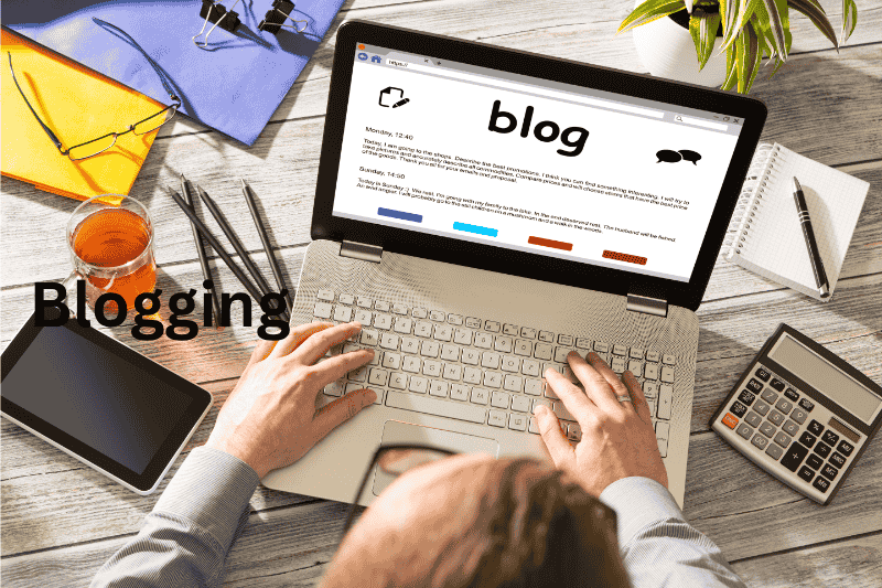 Woman blogging on a laptop at home