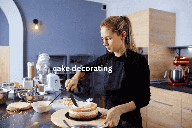 Woman decorating a cake as part of a home baking business