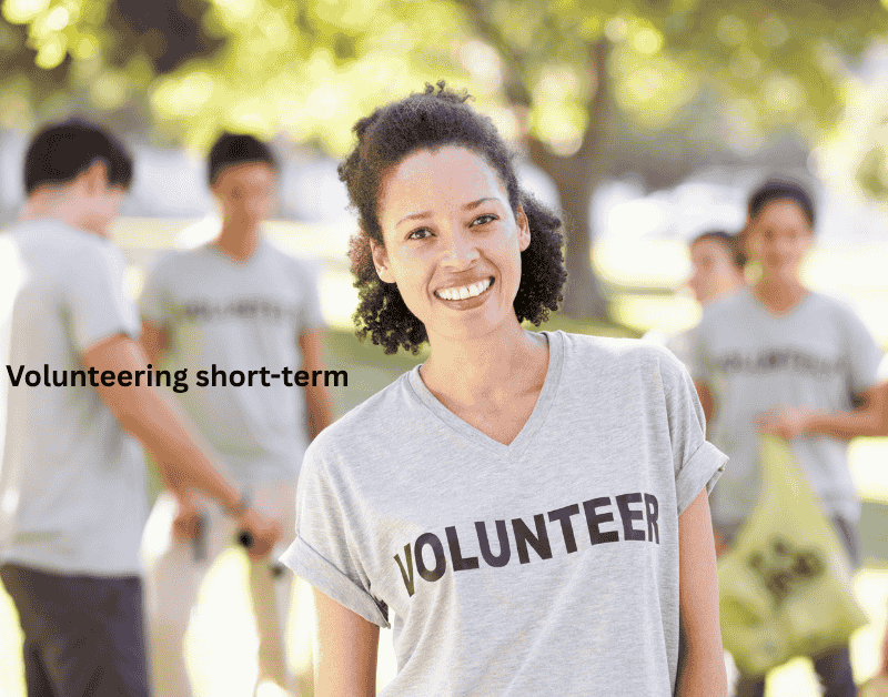 Solo female traveler participating in short-term volunteering, helping a local community during her travel experience.