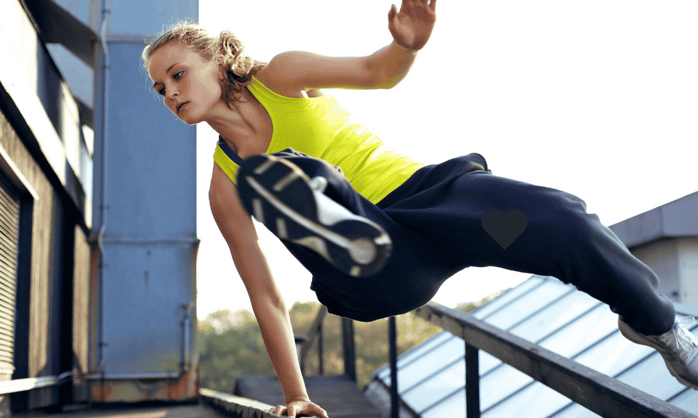 Woman performing a parkour jump over an obstacle — Parkour for Beginners