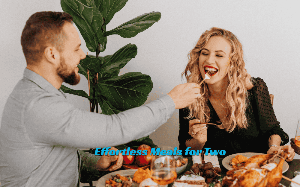 An intimate dinner for two with two bowls of creamy pasta, wine glasses, and a flickering candle on a rustic wooden table.