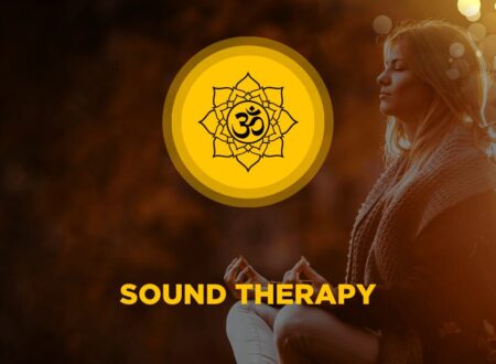 Woman meditating peacefully in warm light with an Om mandala symbol representing sound therapy and healing vibrations.