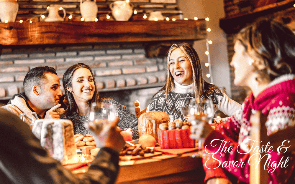 Friends enjoying a cozy holiday dinner with wine, laughter, and festive food during a Taste and Savor Night gathering.