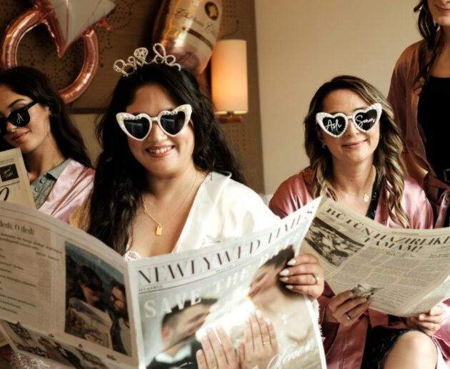 Girls enjoying fun sleepover ideas during a pajama party night with newspapers and themed decorations