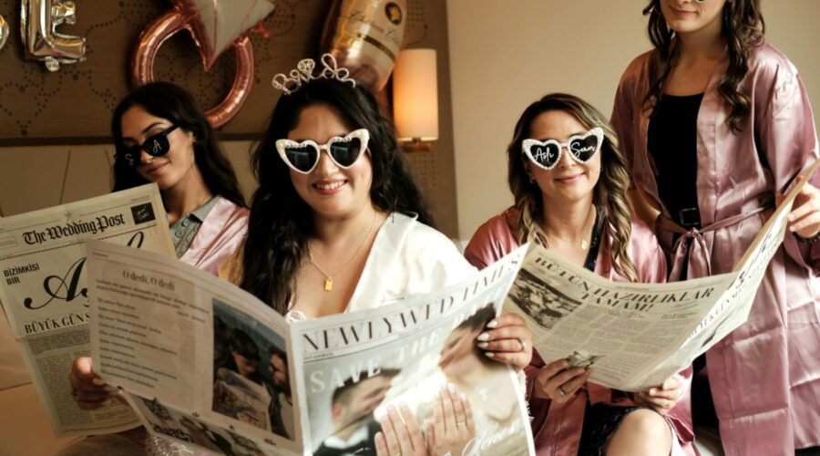 Girls enjoying fun sleepover ideas during a pajama party night with newspapers and themed decorations